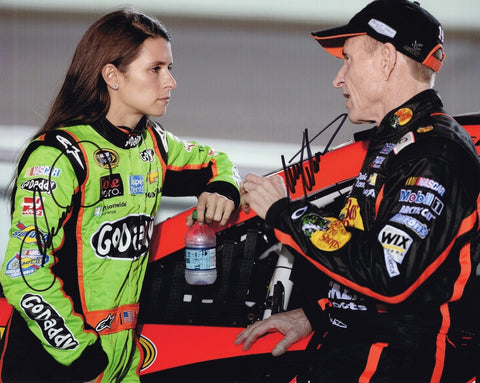Autographed Mark Martin and Danica Patrick Stewart-Haas Racing photo showing both drivers standing together with the Bass Pro Shops #14 and GoDaddy #10 team branding visible behind them. This dual-signed 8x10 NASCAR collectible includes a COA, makes a great gift, and we are always here to help with any questions.
