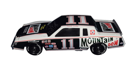 Step back in time with the Autographed 1981 Darrell Waltrip #11 Mountain Dew Racing Diecast Car, a vintage gem. This limited edition collectible takes you to the Buick Regal era, showcasing exclusive signatures acquired through special signings and HOT Pass access. Includes Certificate of Authenticity (COA) – an ideal gift for NASCAR fans and collectors.