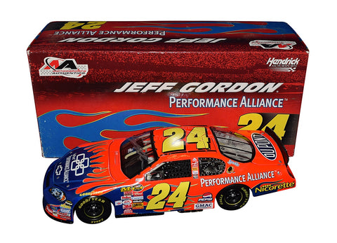 Autographed 2006 Jeff Gordon #24 DuPont Blue Flames Diecast Car Signed - Side View: Vibrant blue flames adorn Jeff Gordon's iconic DuPont car, with authentic signatures adding prestige to this limited-edition collectible.