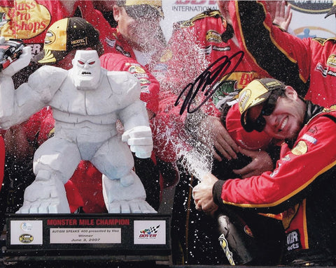 Own a piece of NASCAR history with this authentic autographed 8x10 inch photo of Martin Truex Jr. celebrating his 2007 Dover win, marking his first career victory. Certificate of Authenticity included.