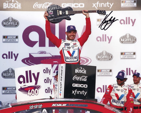 The AUTOGRAPHED #5 Kyle Larson Valvoline Nashville Win 8x10 Inch Photo captures the thrilling moment of Kyle Larson's iconic Victory Lane celebration, complete with the Victory Lane Guitar. This unique collectible showcases a historic milestone in NASCAR history.