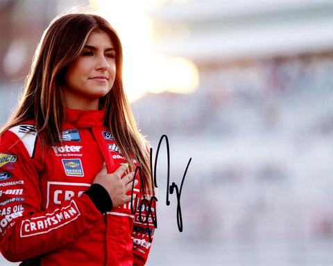 Experience the thrill of NASCAR with an AUTOGRAPHED 2022 Hailie Deegan #1 Craftsman Racing Truck Series 8x10 Inch NASCAR Photo. This iconic collector's piece immortalizes a significant moment as Hailie Deegan embraces the spirit of competition with the pre-race pledge. Her signature, personally obtained through exclusive signings and prized garage area access via HOT Passes.