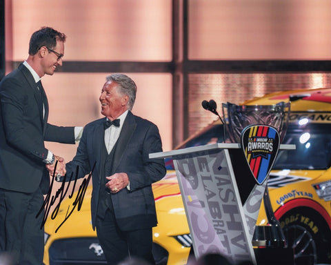 Relive the excitement of Joey Logano's 2022 NASCAR Championship win with the AUTOGRAPHED #22 NASCAR CHAMPION Signed 8x10 Inch Picture. This iconic photo captures Logano's victorious moment at the Nashville Awards Ceremony, surrounded by adoring fans and the championship trophy. 