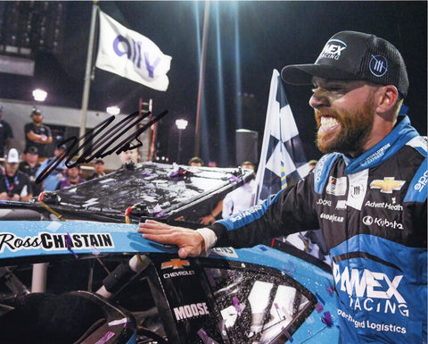 Own a piece of racing history with this authentic autographed 8x10 inch NASCAR photo of Ross Chastain celebrating his 2023 Nashville win in Victory Lane. Certificate of Authenticity included.
