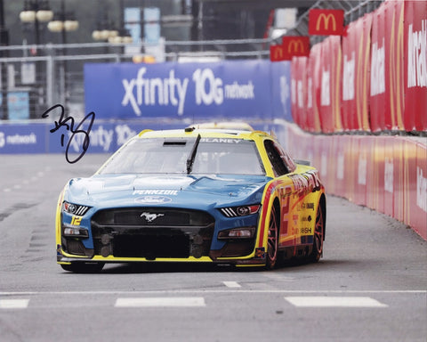 Step into the winner's circle with this AUTOGRAPHED 8x10 Inch NASCAR Photo, capturing the victorious moment of Ryan Blaney at the 2023 Menards CHICAGO STREET RACE, a defining race of his championship season. Every signature on this collectible is meticulously obtained through exclusive public/private signings and exclusive garage area access via HOT Passes, ensuring its authenticity. 
