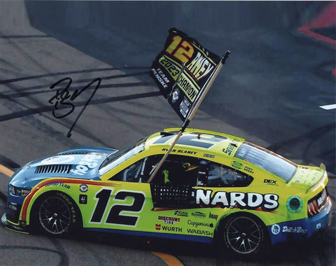 Relive the excitement of Ryan Blaney's championship victory with this autographed 8x10 photo showcasing his championship flag burnout as a NASCAR champion.