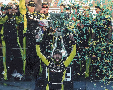 Relive the excitement of Ryan Blaney's NASCAR championship win with this autographed 8x10 photo showcasing his Victory Lane celebration with the trophy.