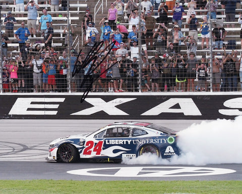 This exclusive collectible features an autographed 2023 William Byron #24 Liberty University TEXAS RACE WIN NASCAR photo, capturing the electrifying moment of victory with Byron's celebratory Victory Burnout. Each signature is meticulously obtained through exclusive public/private signings and garage area access via HOT Passes, ensuring unparalleled authenticity. 