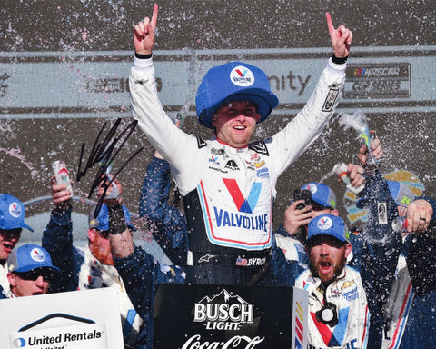 This autographed 2023 William Byron #24 Valvoline Racing PHOENIX WIN NASCAR photo showcases the euphoric moment of victory in Victory Lane at Phoenix Raceway. Each signature is meticulously acquired through exclusive public/private signings and garage area access via HOT Passes, ensuring unparalleled authenticity.