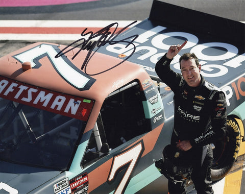 Authentic Kyle Busch signature on glossy NASCAR photo, capturing his triumphant moment at the Atlanta Race driving for Spire Motorsports.