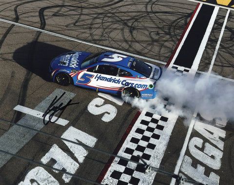 Authentic Kyle Larson signature on glossy NASCAR photo, showcasing his victorious burnout at Las Vegas Motor Speedway.