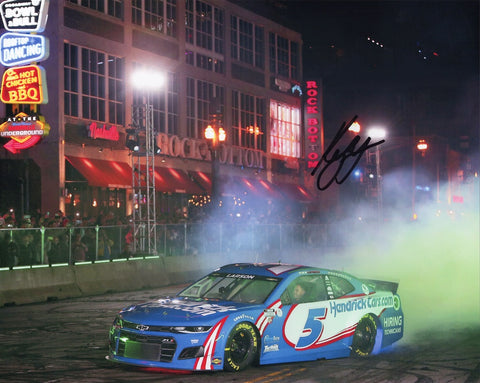Immerse yourself in NASCAR excitement with an AUTOGRAPHED 2021 Kyle Larson #5 Hendrick Motorsports NASHVILLE DOWNTOWN BURNOUT (Awards Week) Signed 8X10 Inch Glossy Photo featuring a thrilling burnout moment in Nashville during Awards Week.