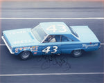 Vintage signed 8x10 photo of Richard Petty’s 1966 #43 Plymouth car at the Daytona 500, a classic collectible that highlights a milestone in NASCAR history.