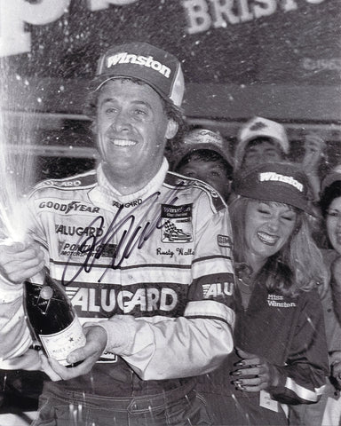 Autographed 1986 Rusty Wallace #27 Alugard Racing Bristol Race Win photo, capturing Wallace celebrating in Victory Lane with champagne. Certified authentic with COA.