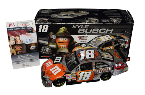 Autographed 2008 Kyle Busch #18 M&M's Halloween NASCAR Diecast Car. Toyota COT Camry model with festive Halloween graphics. Hand-signed by Kyle Busch. Limited edition of 2,668. JSA COA included. Perfect gift for racing fans and Halloween enthusiasts alike.