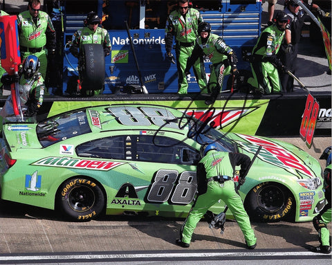 Autographed 2017 Dale Earnhardt Jr. #88 Mountain Dew Racing photo from the Talladega race, showcasing a pit crew stop moment. Signed with COA for authenticity.