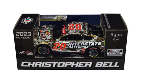 The 2023 Christopher Bell #20 Interstate Batteries Camo NASCAR Salutes diecast car, featuring Christopher Bell's signature obtained through exclusive public and private signings. Comes with a Certificate of Authenticity and a lifetime authenticity guarantee.