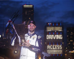 This autographed 8x10 photo shows Shane Van Gisbergen proudly holding the victory trophy after his 2023 Chicago Street Race win, with his #91 Trackhouse Racing car in the background. Includes COA, ideal for any NASCAR collector or fan.