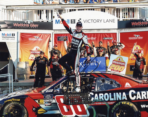 Glossy 8x10 photo of Connor Zilisch celebrating his 2024 Watkins Glen win in the #88 Carolina Carports Xfinity Series car, autographed with COA. Ideal for NASCAR collectors and fans seeking unique memorabilia.