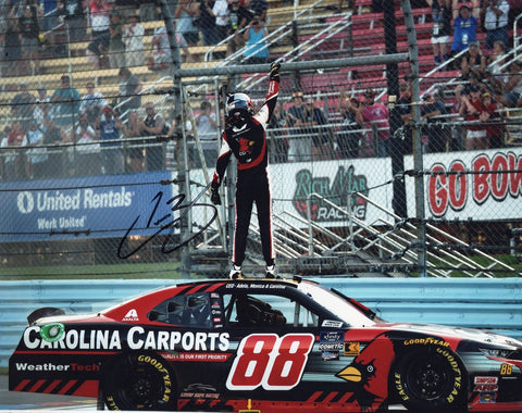 Glossy 8x10 photo of Connor Zilisch celebrating his 2024 Watkins Glen win in the #88 Carolina Carports Xfinity Series car, autographed and ready for display with COA.
