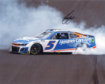 Kyle Larson’s iconic victory burnout at the 2024 Brickyard 400 is captured in this signed 8x10 NASCAR photo. Featuring his Hendrick Motorsports #5 car, this glossy print comes with a COA for authenticity, perfect for fans and collectors.