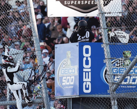 Stunning signed 8x10 photo of Tyler Reddick after his Talladega win, climbing the fence in joy. This iconic moment features the #45 Jumpman car, complete with COA and great for gifting.