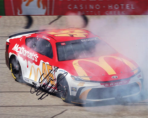Autographed 2024 Tyler Reddick #45 McDonald's Toyota photo from his Michigan victory burnout, signed by Reddick, perfect for NASCAR fans and collectors, with COA for authenticity.