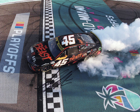 Autographed 2024 Tyler Reddick #45 The Beast Racing Homestead Playoff win finish line burnout photo, showing Reddick celebrating his victory. Signed by Reddick with a Certificate of Authenticity (COA).