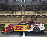 Autographed 8x10 glossy photo of Joey Logano #22 Pennzoil Racing Daytona 500 car, captured in a pit road pose. Signed collectible with COA, ideal for NASCAR enthusiasts and collectors.