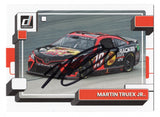 The autographed Martin Truex Jr. 2023 Donruss Racing card featuring the #19 Bass Pro Shops car, complete with an authentic signature and a Certificate of Authenticity.