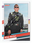 This autographed Riley Herbst 2024 Donruss Racing 1991 Retro Xfinity Series card features the iconic design of the 1991 series. With Riley's signature, it’s a rare collectible with a Certificate of Authenticity, perfect for NASCAR fans.