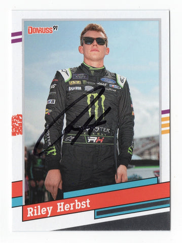 This autographed Riley Herbst 2024 Donruss Racing 1991 Retro Xfinity Series card features the iconic design of the 1991 series. With Riley's signature, it’s a rare collectible with a Certificate of Authenticity, perfect for NASCAR fans.