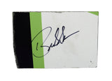 Autographed 2023 Bubba Wallace #23 DraftKings Racing race-used composite NASCAR sheet metal from his Loudon car. This signed collectible is roughly the size of a standard trading card, fits inside a plastic toploader for protection and display, and includes a certificate of authenticity.