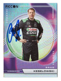 Brad Keselowski is featured on this autographed 2023 Panini Chronicles Racing Recon NASCAR trading card showcasing the distinctive Recon design. Signed by the 2012 NASCAR Cup Series champion and RFK Racing driver and co-owner, this collectible includes a Certificate of Authenticity and celebrates his accomplishments in stock car racing.
