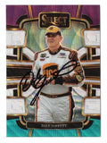 Vibrant purple, white, and teal coloring distinguishes this autographed Dale Jarrett 2024 Panini Select Racing Tricolor Prizm NASCAR trading card. Featuring the 1999 NASCAR Cup Series champion's signature and accompanied by a Certificate of Authenticity, this collectible celebrates the three-time Daytona 500 winner and his legendary racing career.