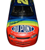 Close-up of the signed 1997 Jeff Gordon #24 DuPont Rainbow Warrior Revell 1/24 NASCAR diecast showing the authentic autograph, classic rainbow flame graphics, and visible paint cracking from age. This loose car has no original packaging and makes a distinctive display piece for Jeff Gordon fans.