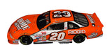 Close-up of the signed 2000 Tony Stewart #20 Home Depot Joe Gibbs Racing Action 1/24 NASCAR diecast showcasing the authentic autograph, vibrant orange racing finish, detailed sponsor graphics, and classic Action craftsmanship. An eye-catching collectible from Stewart's early NASCAR Cup Series career with Joe Gibbs Racing.