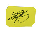 Close-up of signed Kyle Busch 2007 Cheez-It and CarQuest race-used sheet metal from the Texas NASCAR race showing authentic race scuffs, detailed graphics, and collectible NASCAR history. Includes a plastic toploader for protection and display and makes a great gift for racing fans.