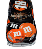 Detailed side profile of the autographed 2009 Kyle Busch #18 M&M’s Halloween Joe Gibbs Racing 1/24 scale diecast showcasing premium Action Racing craftsmanship, realistic interior detail, rubber tires, and race-inspired graphics. Includes Certificate of Authenticity and makes a fantastic display piece for NASCAR fans.