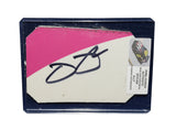 Displayed autographed Jimmie Johnson #48 Ally Racing two-color pink race-used NASCAR sheet metal featuring visible track wear and Hendrick Motorsports styling. Housed inside a protective plastic toploader, this trading-card-size collectible makes a great gift for Jimmie Johnson fans and racing memorabilia collectors.