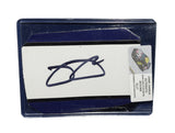Displayed autographed Jimmie Johnson #48 Ally Racing two-color race-used NASCAR sheet metal featuring visible racing wear and Hendrick Motorsports styling. Housed inside a protective plastic toploader, this trading-card-size collectible makes a great gift for Jimmie Johnson fans and racing memorabilia collectors.