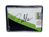 Displayed autographed Bubba Wallace #23 DraftKings Racing composite NASCAR sheet metal from the 2023 Crayon 301 Loudon car with visible racing wear. Housed inside a protective plastic toploader, this trading-card-size collectible makes a great gift for Bubba Wallace fans and motorsports memorabilia collectors.