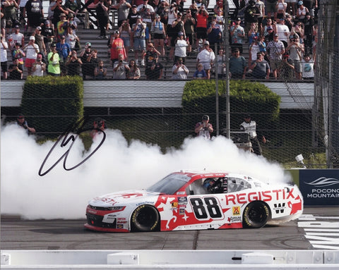 Autographed 8x10 photo of Connor Zilisch celebrating his 2025 Pocono victory with a dramatic burnout in the #88 Registix Racing car. The signature and COA enhance its collectible value. It makes a great gift for racing enthusiasts, and we are always here to help with any questions.
