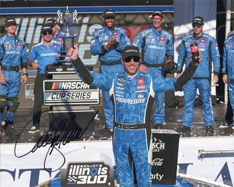 Autographed 8x10 image of Denny Hamlin celebrating his 2025 Gateway race win in Victory Lane with the Progressive Racing No. 11 Toyota, featuring vibrant sponsor colors and post-race energy. A great NASCAR gift for collectors, and we are always here to help with any questions.