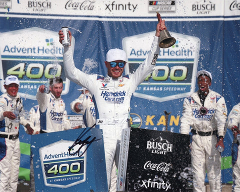 Autographed 8x10 photo of Kyle Larson celebrating his 2025 Kansas Speedway win, ringing the Victory Lane bell beside the #5 Hendrick Racing Chevrolet. This signed NASCAR collectible makes a great gift for fans, and we are always here to help with any questions about this item.