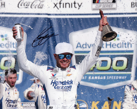 Autographed 8x10 photo of Kyle Larson celebrating his 2025 Kansas Speedway win, shown holding the Victory Lane trophy beside the #5 Hendrick Racing Chevrolet. A detailed NASCAR collectible that makes a great gift for racing fans, and we are always here to help with any questions.