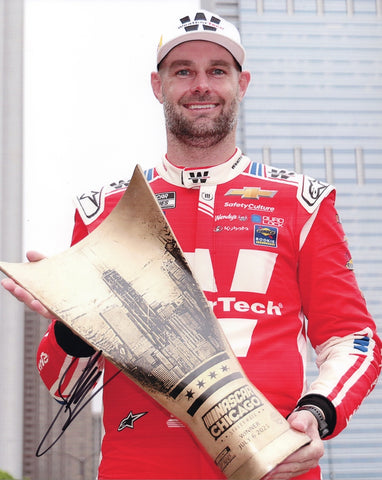 Autographed 2025 Shane Van Gisbergen Chicago Street Race Win trophy photo showing SVG proudly holding the race trophy beside the #88 WeatherTech Racing car. This signed 8x10 NASCAR collectible includes a COA, makes a great gift, and we are always here to help with any questions.