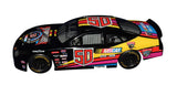 Close-up of the signed Jeff Gordon 1998 NASCAR 50th Anniversary Ford Taurus Black Program Car 1/24 scale diecast showcasing authentic autograph, detailed black commemorative paint scheme, collector-quality craftsmanship, and an included Certificate of Authenticity.